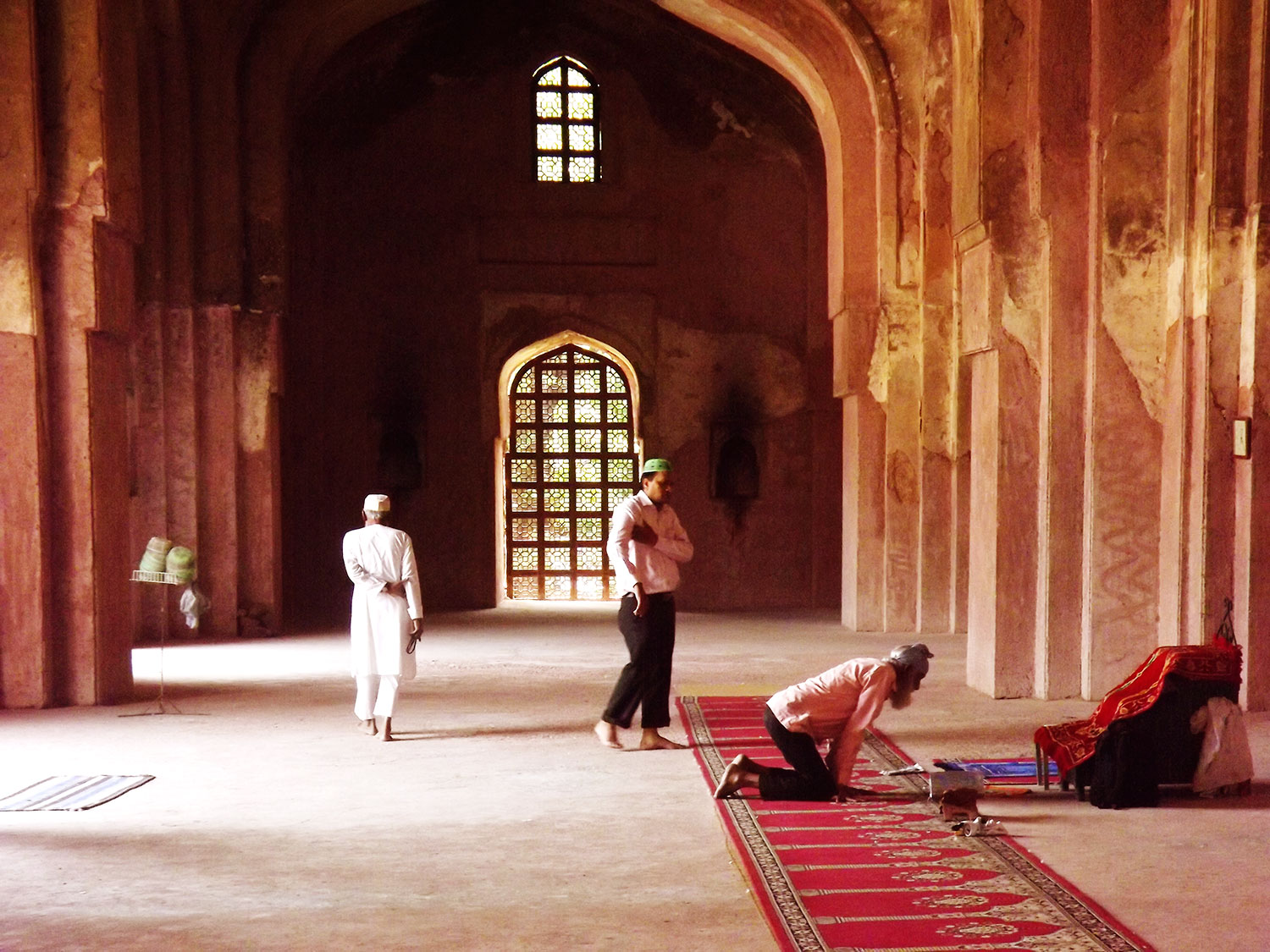 The photo shows Islamic worshipers preparing for the Asr midday prayers inside the 15th century early Mughal mosque of Khair-Ul-Manzil at Mathura Road, New Delhi, India