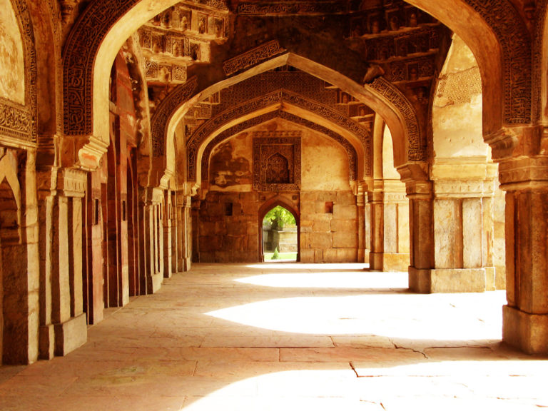 View of the interior of the Friday mosque of Sikander Lodi with ornamented archways and sunlight forming arched doorways in Lodi Gardens, New Delhi, India