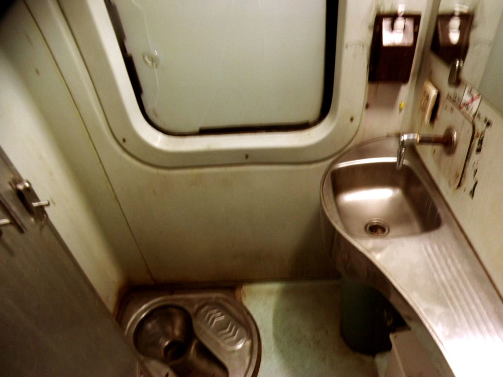 A Farbound.Net Photo showing an Indian style squat commode onboard a Ranchi-Rajdhani Ac 3 tire coach.