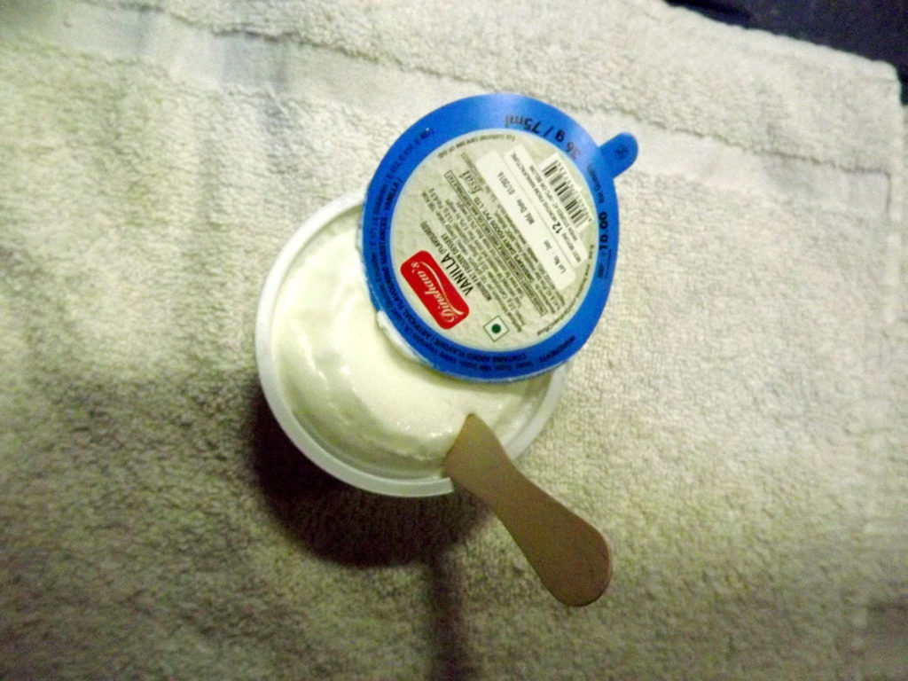 A Farbound.Net Photo showing an ice cream cup onboard the Ranchi-Rajdhani Ac 3 tire coach.