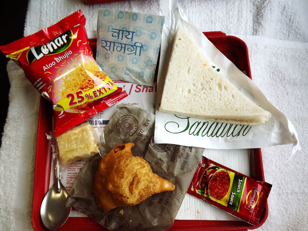 A Farbound.Net Photo showing a snacks tray onboard a Ranchi-Rajdhani Ac 3 tire coach.