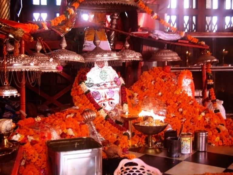 Photo shows a reclining statue of Hanuman decked with garlands at Pandupol, Sariska.