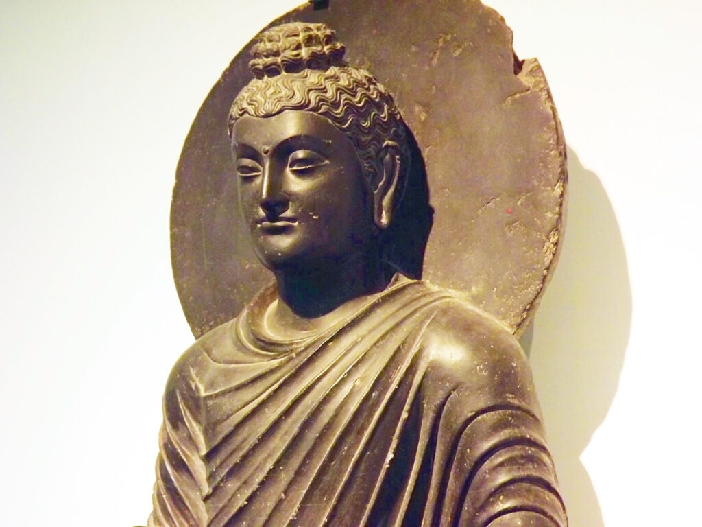 Image is a Farbound.Net Photo: Showing a standing sculpture of Buddha from the region of Gandhara, Kushan period 2 CE.